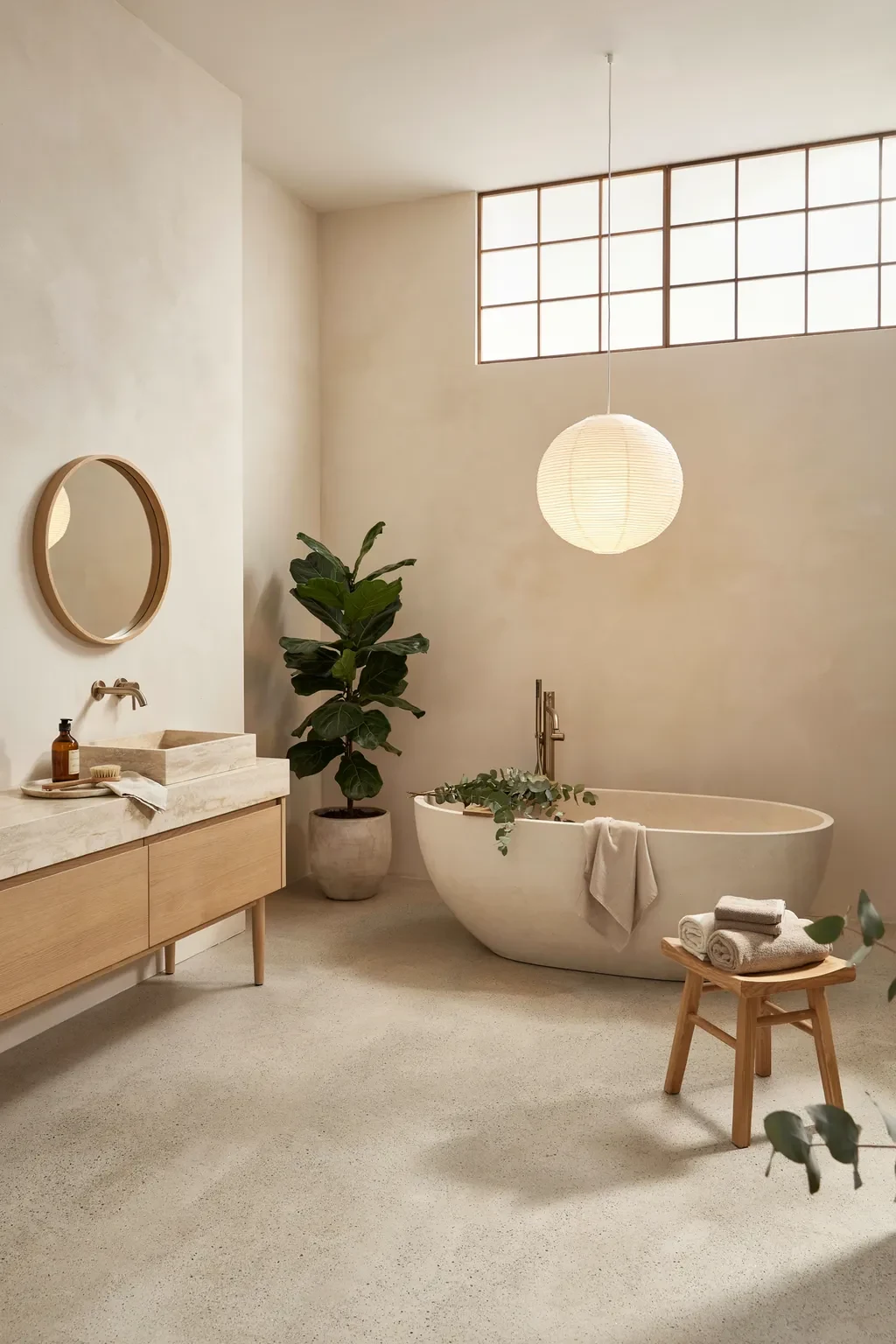 Japandi bathroom with a terrazzo floor, plaster walls and a stone tub