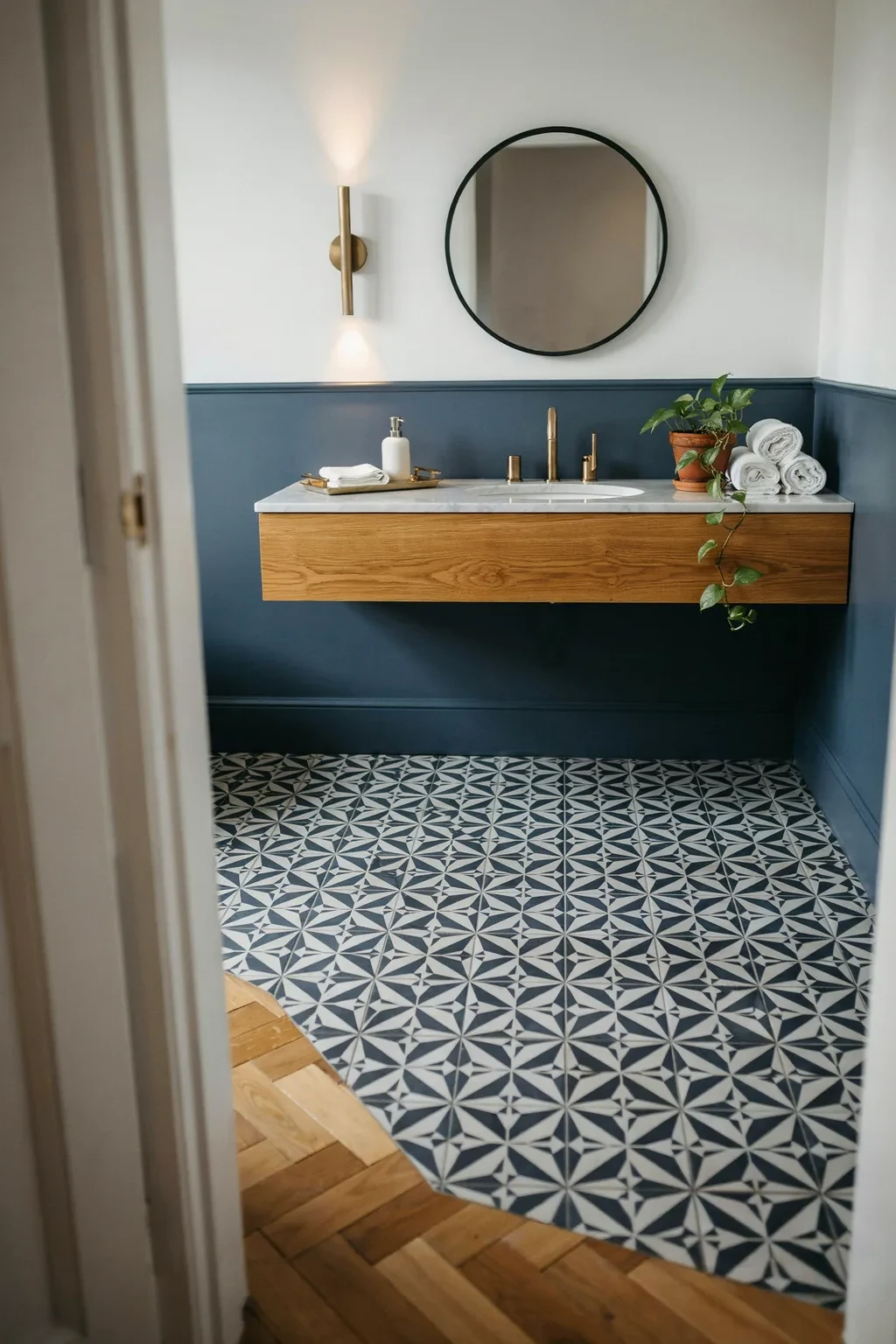 Powder room with a navy and white geometric encaustic tile floor